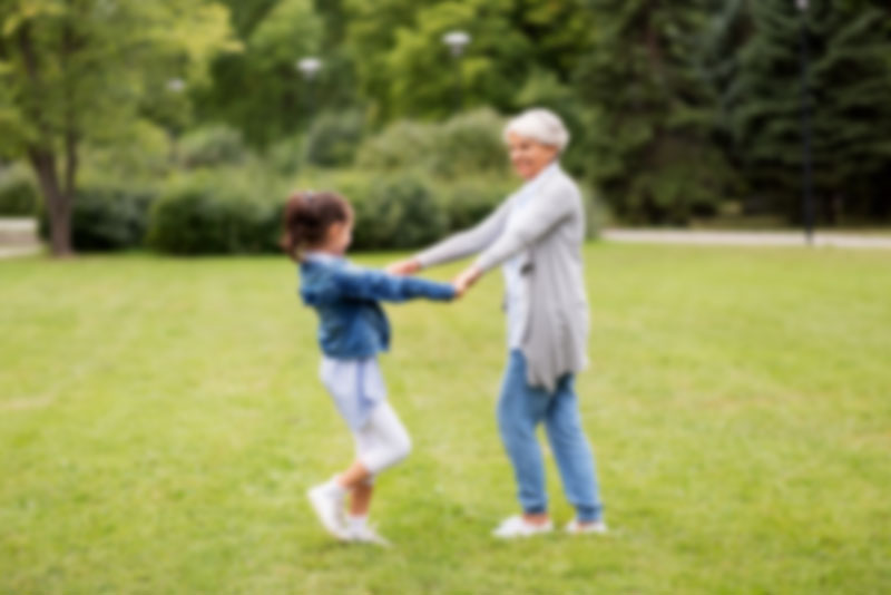 Cloudy Image of an Elderly Woman Playing With a Child