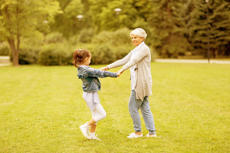 Elderly Woman Playing With a Child With a Fading Yellow Overlay