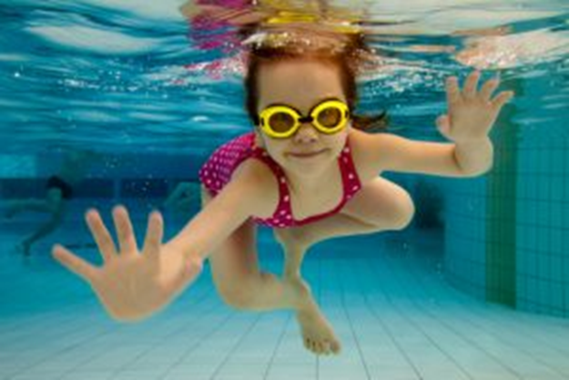 child swimming with goggles